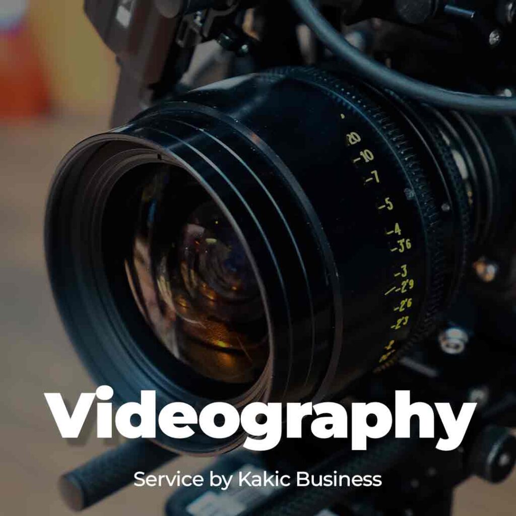 Videography service button for Kakic Business. Close-up of a professional cinema camera lens with visible aperture and focus markings, representing high-quality video production and technical precision.