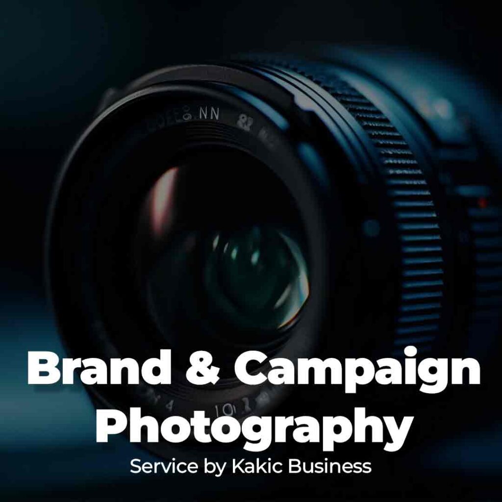 Brand & Campaign Photography service button for Kakic Business. Features a sharp, professional macro shot of a camera lens with technical markings, representing high-stakes commercial imaging and corporate brand development.
