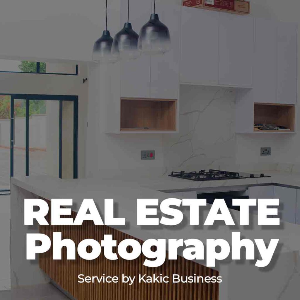 Real Estate Photography service button for Kakic Business. Features a bright, modern kitchen interior with clean white cabinetry and marble finishes, representing professional architectural and property photography.